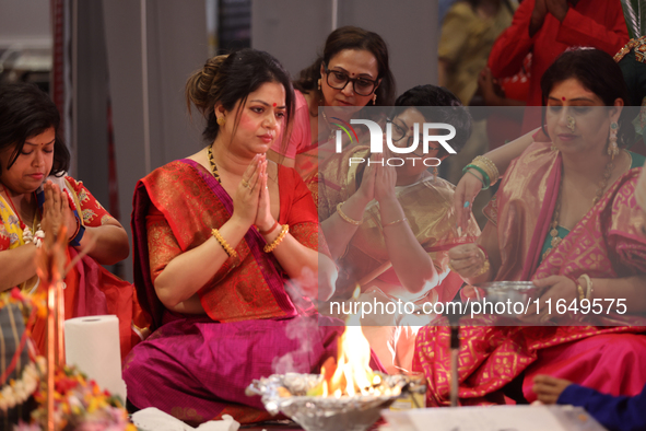 Bengali Hindu women perform prayers during the Durga Puja festival at a pandal (temporary temple) in Mississauga, Ontario, Canada, on Octobe...