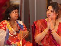 Bengali Hindu women offer prayers during the Durga Puja festival at a pandal (temporary temple) in Mississauga, Ontario, Canada, on October...