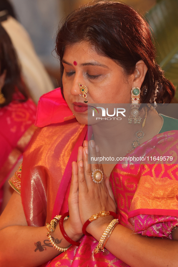 A Bengali Hindu woman offers prayers during the Durga Puja festival at a pandal (temporary temple) in Mississauga, Ontario, Canada, on Octob...