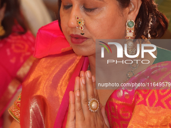 A Bengali Hindu woman offers prayers during the Durga Puja festival at a pandal (temporary temple) in Mississauga, Ontario, Canada, on Octob...