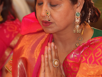 A Bengali Hindu woman offers prayers during the Durga Puja festival at a pandal (temporary temple) in Mississauga, Ontario, Canada, on Octob...