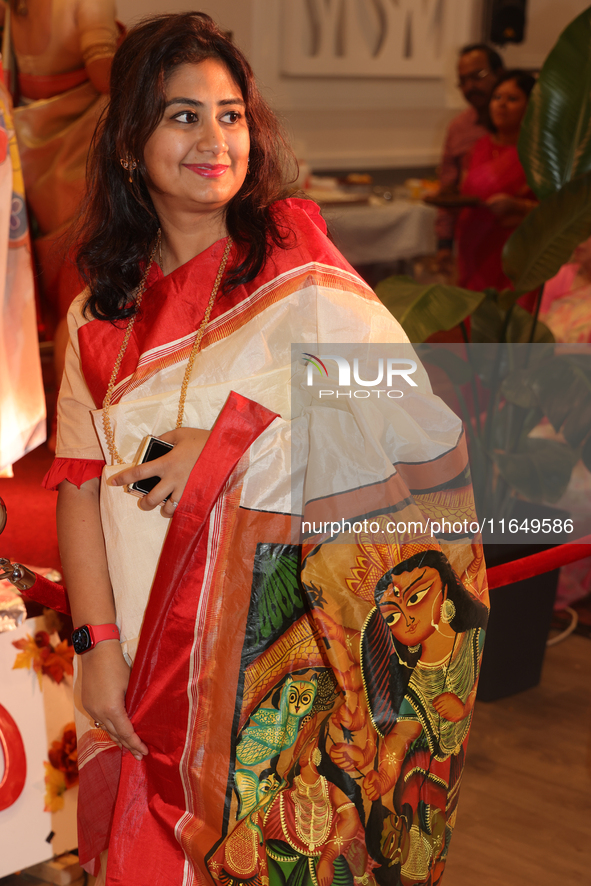 A Bengali Hindu woman wears a saree with the image of the Goddess Durga during the Durga Puja festival at a pandal in Mississauga, Ontario,...