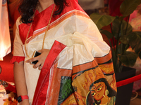 A Bengali Hindu woman wears a saree with the image of the Goddess Durga during the Durga Puja festival at a pandal in Mississauga, Ontario,...