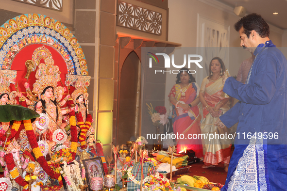 A Bengali Hindu priest performs prayers during the Durga Puja festival at a pandal (temporary temple) in Mississauga, Ontario, Canada, on Oc...