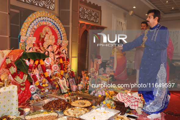 A Bengali Hindu priest performs prayers during the Durga Puja festival at a pandal (temporary temple) in Mississauga, Ontario, Canada, on Oc...