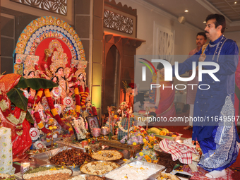 A Bengali Hindu priest performs prayers during the Durga Puja festival at a pandal (temporary temple) in Mississauga, Ontario, Canada, on Oc...