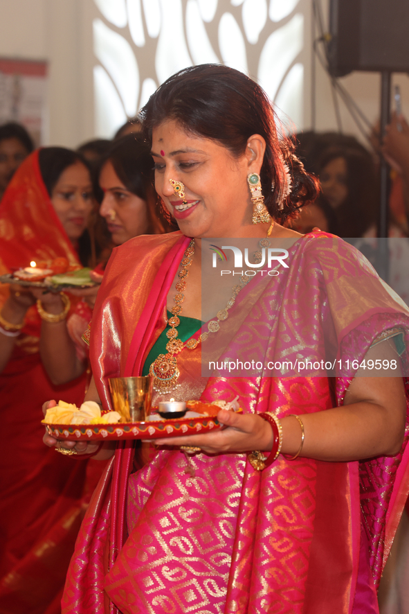 Bengali Hindu women perform prayers during the Durga Puja festival at a pandal (temporary temple) in Mississauga, Ontario, Canada, on Octobe...