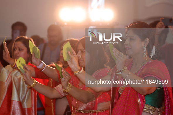 Bengali Hindu women perform prayers during the Durga Puja festival at a pandal (temporary temple) in Mississauga, Ontario, Canada, on Octobe...