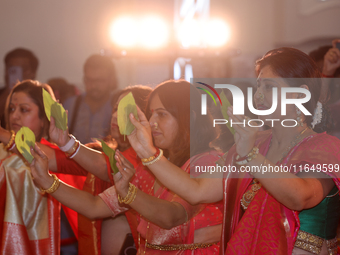 Bengali Hindu women perform prayers during the Durga Puja festival at a pandal (temporary temple) in Mississauga, Ontario, Canada, on Octobe...