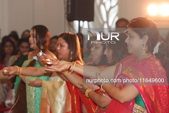 Bengali Hindu women perform prayers during the Durga Puja festival at a pandal (temporary temple) in Mississauga, Ontario, Canada, on Octobe...