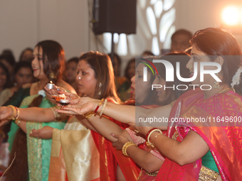 Bengali Hindu women perform prayers during the Durga Puja festival at a pandal (temporary temple) in Mississauga, Ontario, Canada, on Octobe...