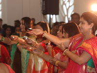 Bengali Hindu women perform prayers during the Durga Puja festival at a pandal (temporary temple) in Mississauga, Ontario, Canada, on Octobe...