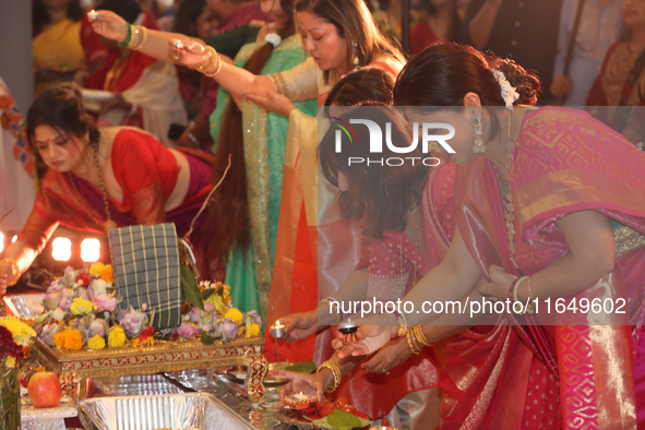 Bengali Hindu women perform prayers during the Durga Puja festival at a pandal (temporary temple) in Mississauga, Ontario, Canada, on Octobe...