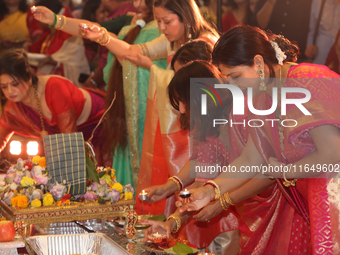 Bengali Hindu women perform prayers during the Durga Puja festival at a pandal (temporary temple) in Mississauga, Ontario, Canada, on Octobe...