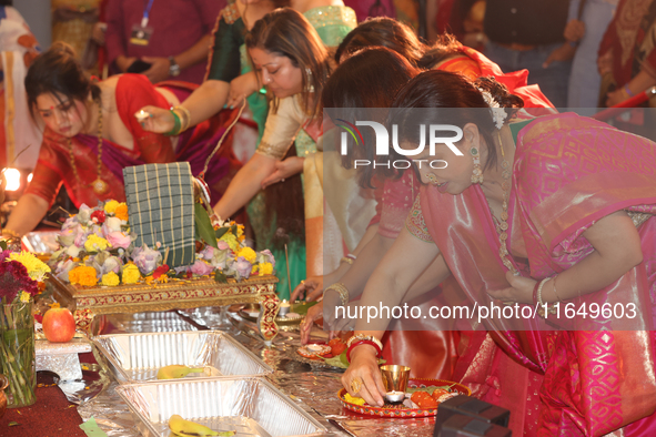 Bengali Hindu women perform prayers during the Durga Puja festival at a pandal (temporary temple) in Mississauga, Ontario, Canada, on Octobe...