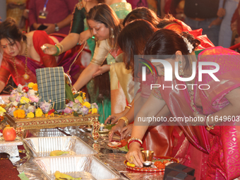 Bengali Hindu women perform prayers during the Durga Puja festival at a pandal (temporary temple) in Mississauga, Ontario, Canada, on Octobe...