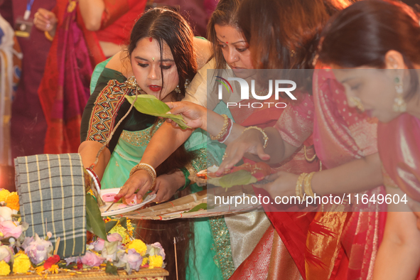 Bengali Hindu women perform prayers during the Durga Puja festival at a pandal (temporary temple) in Mississauga, Ontario, Canada, on Octobe...