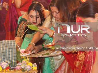 Bengali Hindu women perform prayers during the Durga Puja festival at a pandal (temporary temple) in Mississauga, Ontario, Canada, on Octobe...