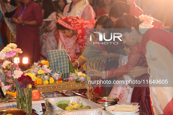 Bengali Hindu women perform prayers during the Durga Puja festival at a pandal (temporary temple) in Mississauga, Ontario, Canada, on Octobe...