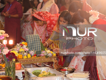 Bengali Hindu women perform prayers during the Durga Puja festival at a pandal (temporary temple) in Mississauga, Ontario, Canada, on Octobe...