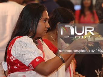 Bengali Hindu women perform prayers during the Durga Puja festival at a pandal (temporary temple) in Mississauga, Ontario, Canada, on Octobe...