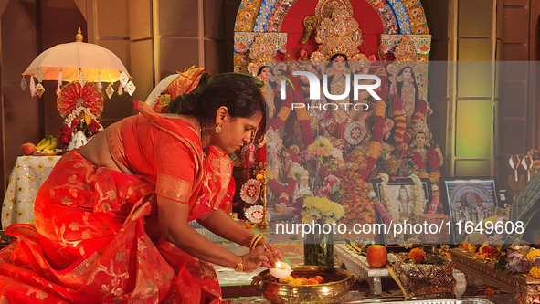 A Bengali Hindu woman performs prayers during the Durga Puja festival at a pandal (temporary temple) in Mississauga, Ontario, Canada, on Oct...