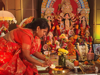 A Bengali Hindu woman performs prayers during the Durga Puja festival at a pandal (temporary temple) in Mississauga, Ontario, Canada, on Oct...