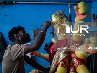 Bangladeshi artisans prepare a clay idol of the Hindu Goddess Durga for the upcoming Hindu religious festival Durga Puja in Dhaka, Banglades...