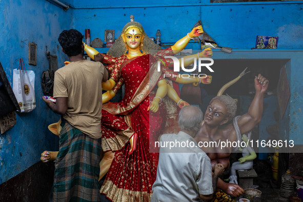 Bangladeshi artisans prepare a clay idol of the Hindu Goddess Durga for the upcoming Hindu religious festival Durga Puja in Dhaka, Banglades...