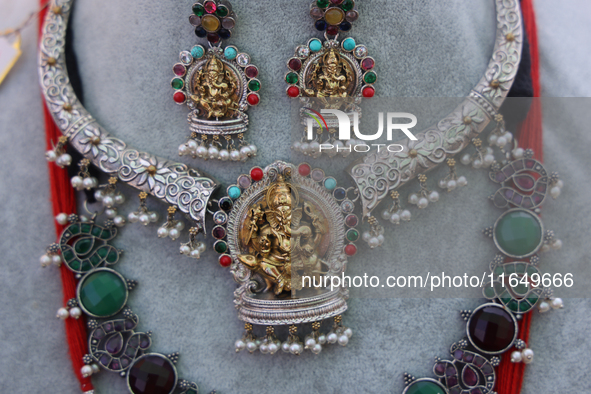 Indian jewellery is adorned with small figures of Lord Ganesh at a stall selling costume jewellery and temple jewellery during the Sree Gane...