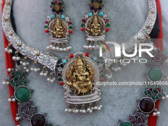 Indian jewellery is adorned with small figures of Lord Ganesh at a stall selling costume jewellery and temple jewellery during the Sree Gane...