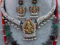 Indian jewellery is adorned with small figures of Lord Ganesh at a stall selling costume jewellery and temple jewellery during the Sree Gane...