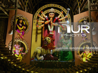 An idol of the Hindu goddess 'Durga' is pictured as devotees arrive to see it during the Durga Puja festival in Siliguri, India, on October...