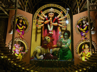 An idol of the Hindu goddess 'Durga' is pictured as devotees arrive to see it during the Durga Puja festival in Siliguri, India, on October...