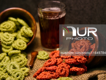 Palak murukku (spinach murukku) and beetroot murukku are served with black tea in Toronto, Ontario, Canada, on October 8, 2024. Murukku is a...