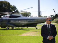 A U.S. Secret Service officer stands guard on the South Lawn of the White House on October 8, 2024 as Marine One prepares to take off with P...