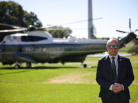 A U.S. Secret Service officer stands guard on the South Lawn of the White House on October 8, 2024 as Marine One prepares to take off with P...