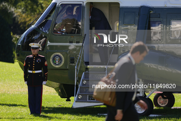 U.S. President Joe Biden salutes a U.S. Marine as he boards Marine One on the South Lawn of the White House, en route to Milwaukee, Wisconsi...