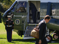 U.S. President Joe Biden salutes a U.S. Marine as he boards Marine One on the South Lawn of the White House, en route to Milwaukee, Wisconsi...