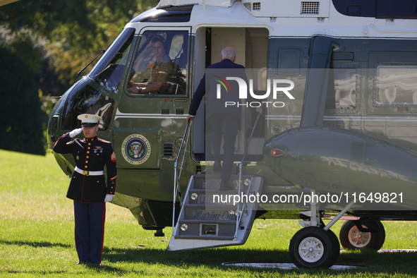 U.S. President Joe Biden salutes a U.S. Marine as he boards Marine One on the South Lawn of the White House, en route to Milwaukee, Wisconsi...