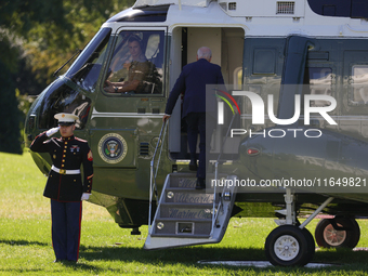 U.S. President Joe Biden salutes a U.S. Marine as he boards Marine One on the South Lawn of the White House, en route to Milwaukee, Wisconsi...