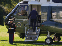 U.S. President Joe Biden salutes a U.S. Marine as he boards Marine One on the South Lawn of the White House, en route to Milwaukee, Wisconsi...