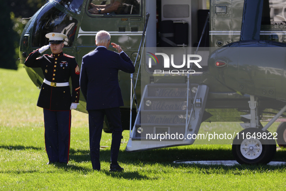 U.S. President Joe Biden salutes a U.S. Marine as he boards Marine One on the South Lawn of the White House, en route to Milwaukee, Wisconsi...