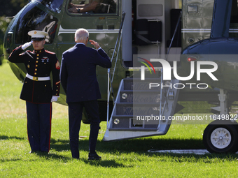 U.S. President Joe Biden salutes a U.S. Marine as he boards Marine One on the South Lawn of the White House, en route to Milwaukee, Wisconsi...