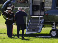 U.S. President Joe Biden salutes a U.S. Marine as he boards Marine One on the South Lawn of the White House, en route to Milwaukee, Wisconsi...