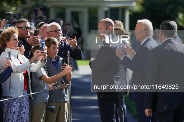 U.S. President Joe Biden speaks with guests at the White House before boarding Marine One en route to Milwaukee, Wisconsin and Philadelphia,...