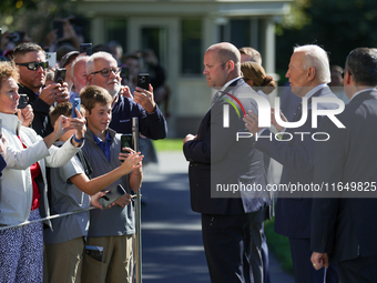 U.S. President Joe Biden speaks with guests at the White House before boarding Marine One en route to Milwaukee, Wisconsin and Philadelphia,...