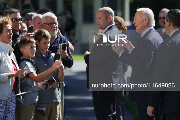 U.S. President Joe Biden speaks with guests at the White House before boarding Marine One en route to Milwaukee, Wisconsin and Philadelphia,...