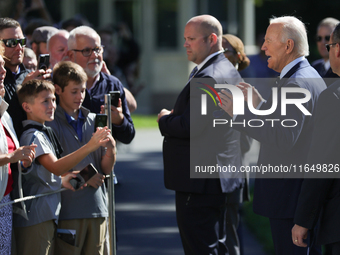 U.S. President Joe Biden speaks with guests at the White House before boarding Marine One en route to Milwaukee, Wisconsin and Philadelphia,...