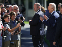 U.S. President Joe Biden speaks with guests at the White House before boarding Marine One en route to Milwaukee, Wisconsin and Philadelphia,...